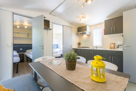 Interior luminoso y moderno de Mobile Home Capri en Camping Zelena Laguna, Croacia, con cocina y comedor.