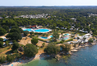 Luftaufnahme vom Camping Polari in Istrien, Kroatien mit Pools, viel Grün und direktem Zugang zum Meer.