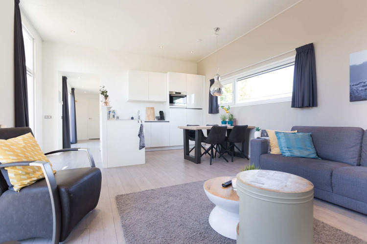 Modern living room and kitchen at Collosseo Wellness (Spa) in Résidence Valkenburg, Netherlands, bright and stylish decor.