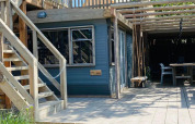 Bright wooden terrace and lodge with outdoor stairs and swings at Lodge 5, 7Huizen aan Zee, Netherlands