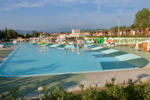 Stor swimmingpool i Camping Cisano/San Vito feriepark i Veneto, Italien, med liggestole og legeområde.