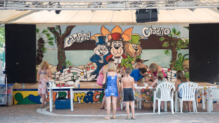 Children and adults enjoy a creative activity at Camping Cisano/San Vito holiday park in Veneto, Italy.