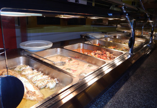 Buffet with hot dishes at Camping Pra'delle Torri holiday park in Veneto, Italy.