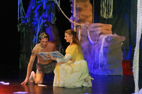 Two actors perform on stage at Camping Pra'delle Torri, Veneto, Italy, with a jungle set in the background.