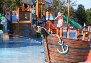 Child plays on a pirate ship in the water park at Camping Pra'delle Torri holiday park in Veneto, Italy.
