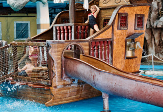 Children playing on a pirate ship water playground at Camping Terme Catez holiday park in Slovenia.