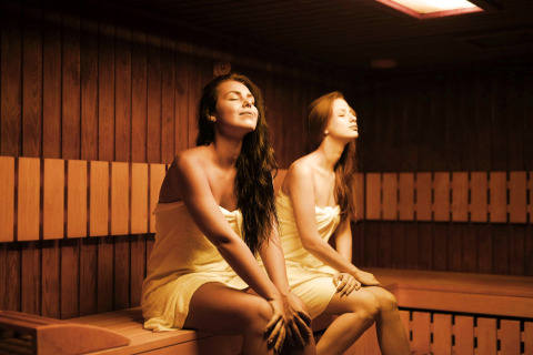 Two women relaxing in a sauna, one of the highlights of Camping Terme Catez holiday park in Slovenia.