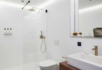 Modern bathroom in Unbrick One, Netherlands, featuring a walk-in shower, wall toilet, and minimalist design.