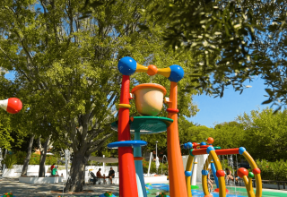 Colorful water playground structures at Camping Zelena Laguna holiday park in Istria, Croatia on a sunny day.