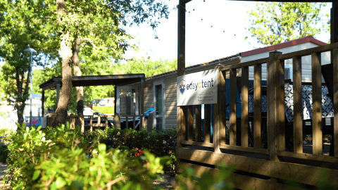 Wooden cabin with an 'Easytent' sign at Camping Bijela Uvala holiday park in Istria, Croatia, among greenery.