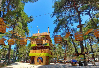 Adventure ropes course with barrel obstacles at Camping Stella Maris holiday park in Istria, Croatia.