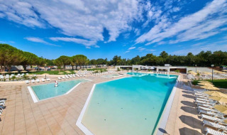 Gran piscina exterior con tumbonas en Camping Stella Maris, un parque vacacional en Istria, Croacia.