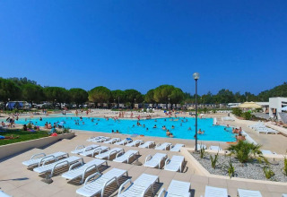 Outdoor swimming pool with sun loungers and vacationers at Camping Stella Maris holiday park in Istria, Croatia.