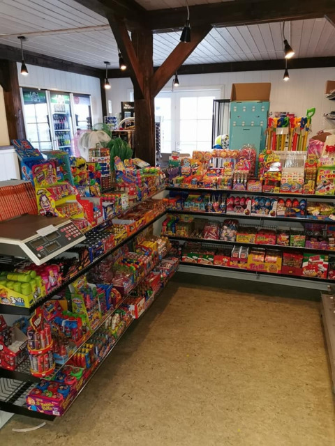 Shelves filled with colorful candy at Toftum Bjerge Camping, a holiday park in Central Denmark Region.