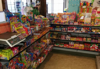 Shelves filled with colorful candy at Toftum Bjerge Camping, a holiday park in Central Denmark Region.