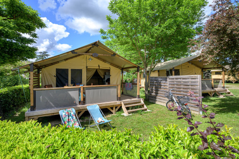 Safari-Zelt Lodge Bali Confort 30m² ohne eigenes Bad, gemütlich gelegen im Grünen mit Fahrrad davor.