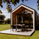 Modern tiny house with a wooden deck and outdoor table at Holiday park Eigen Wijze in the Netherlands.