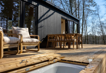 Buitenterras bij Koya Tiny Cabin met houten meubilair en boszicht in Wilsumer Berge, Duitsland.