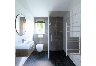 Baño moderno en una cabaña con inodoro suspendido, lavabo, ducha a ras y ventana luminosa al fondo.