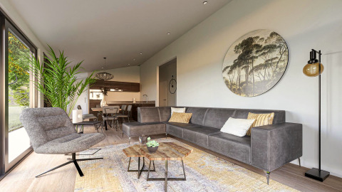 Modern lodge living room with gray sofa, large plant, round wall art, and open kitchen in the background.