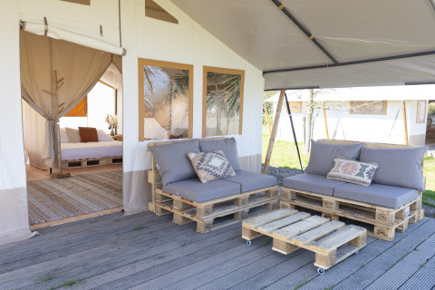 Outdoor seating area with pallet furniture at the Safari Tent Lodge, TinyParks Cast Away, Netherlands.