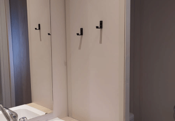 Modernes Badezimmer im Chalet Cajou Confort mit Waschbecken, Spiegel, Handtüchern und WC im Flower Camping La Rivière.