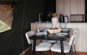 Comedor moderno en Waterlodge, Recreatiepark De Achterste Hoef, Países Bajos, con mesa y cocina.