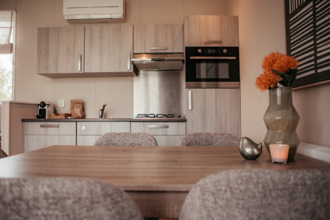 Modern kitchen and dining area inside a luxury chalet at Recreatiepark De Achterste Hoef, Netherlands.