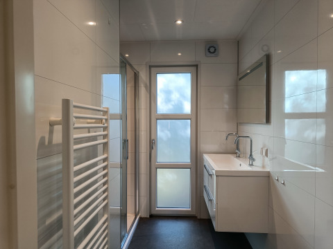 Moderne, lichte badkamer in L-Cube 4+2 lodge bij De Utrechtse Heuvelrug, Nederland, met glazen douche.