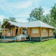 Safari Villa tent accommodation at Holiday park De Boshoek, Netherlands, set in a sunny green area.