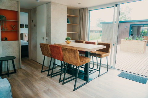 Spisestue ved Family Lodge på Holiday park De Boshoek i Holland med moderne indretning og udsigt til terrassen.