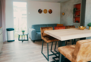 Family Lodge at Holiday park De Boshoek in the Netherlands, featuring a modern, cozy living and dining area.