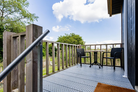 Kleine Terrasse mit Tisch und zwei Stühlen beim Tiny House XL in The Kremmer, Niederlande, Naturkulisse.