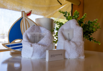 Luxury toiletries and towels in Safari tent Heeg at Marina Heeg, Netherlands, with boat decor in background.
