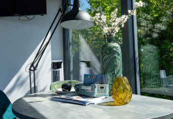 Sonnenlicht fällt auf modernen Tisch mit dekorativen Vasen im Houseboat Heeg bei Marina Heeg, Niederlande.