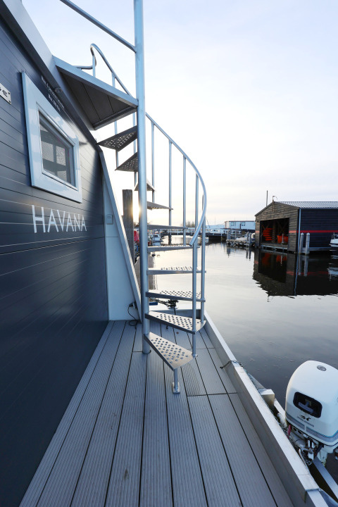 Spiralttreppe auf einem Hausboot im Marina Parcs - Jachthaven De Hoop, Niederlande, bei Sonnenuntergang.