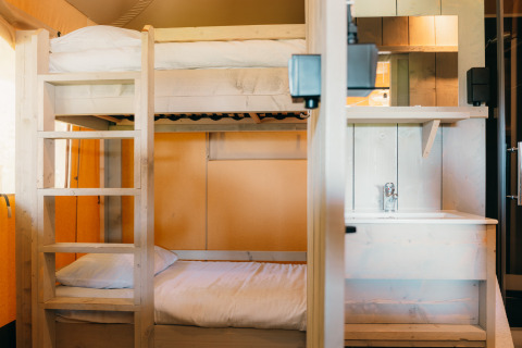 Bunk bed and washbasin inside Safari Cottage tent at Holiday Park Sallandshoeve, Netherlands.