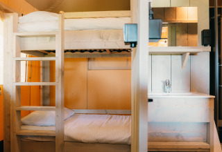 Bunk bed and washbasin inside Safari Cottage tent at Holiday Park Sallandshoeve, Netherlands.