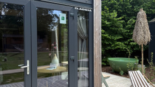 Outdoor terrace and glass doors of Tiny Home MET DUTCHTUB - GENT at Urban-Gardens in Belgium.