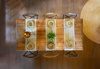 Dining table set for six, viewed from above, at 'Huys van de Boswachter' in Sandberghe, Netherlands.