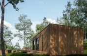 Houten chalet in Hameau de l'Ourthe vakantiepark in België Luxemburg, omgeven door groene bomen.