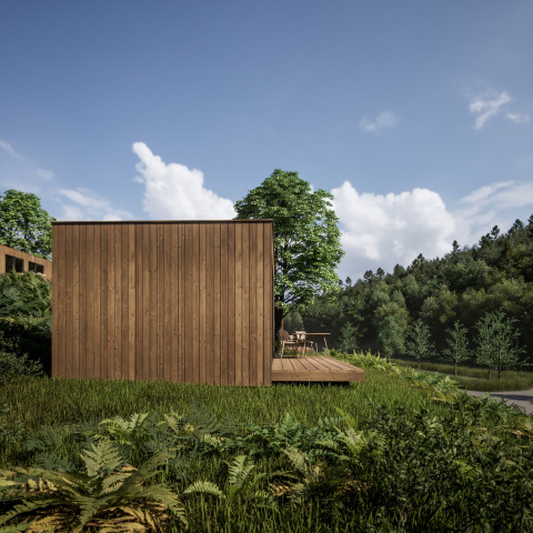 Wooden cabin at Hameau de l'Ourthe holiday park, Belgium Luxembourg, surrounded by lush green trees.