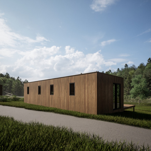 Et moderne træhus ved Hameau de l'Ourthe feriepark omgivet af frodigt grønt og blå himmel i Belgien.