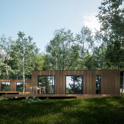 Moderne houten huisjes omringd door bomen in Hameau de l'Ourthe, een vakantiepark in Belgisch Luxemburg.