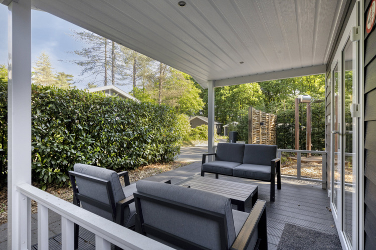 Covered patio with modern outdoor seating at Wellness Lodge for two at De Thijmse Berg, Netherlands.