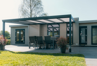 Villa Veluwe en el parque vacacional De Boshoek, Países Bajos, con terraza techada y comedor exterior.