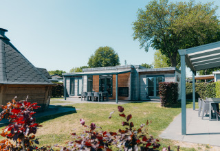 Veluwe Villa with sauna at Holiday park De Boshoek, Netherlands. Modern lodge with outdoor seating area.