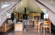 Interior of the Glampinglodge de luxe safari tent with private bathroom at Domaine Bonneblond, France.
