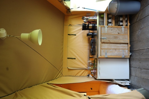 Kitchen area inside a safari tent with private sanitary facilities at Domaine Bonneblond, France.