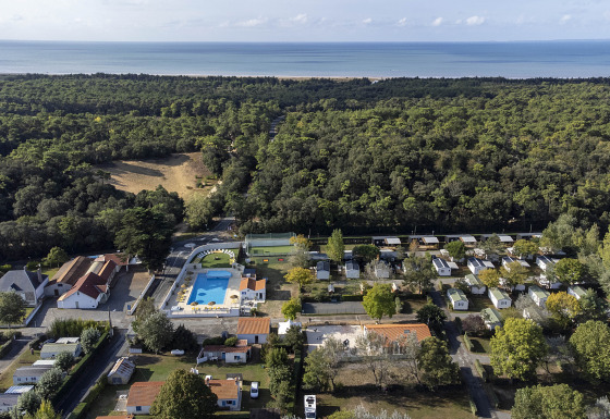 Aerial view of Flower Camping La Davière Plage holiday park in Pays de la Loire, France, with pool and forest.